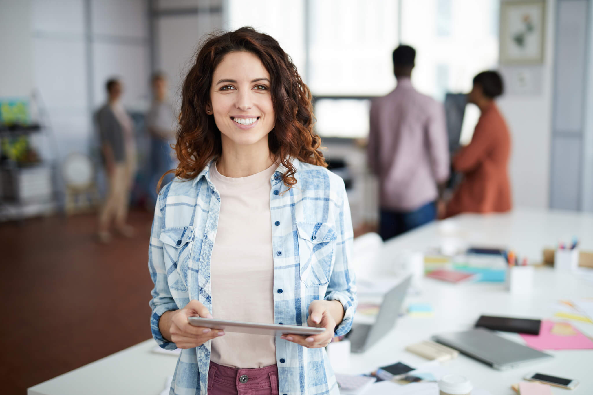 cheerful young woman posing in creative agency