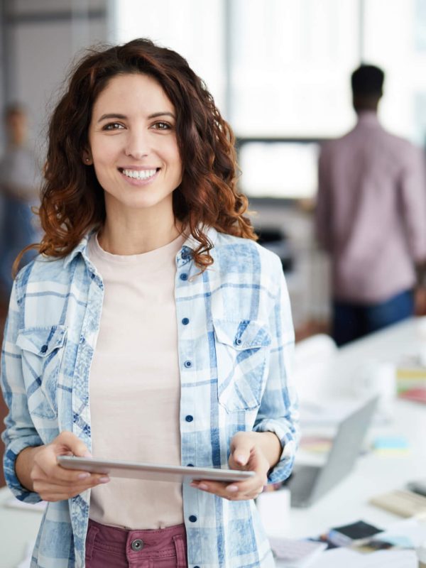 cheerful young woman posing in creative agency